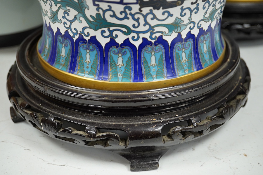 A pair of Chinese blue and white dragon decorated cloisonné enamel jars and covers on stands, 45cm high and a Japanese enamelled porcelain vase, early 20th century. (3). Condition - good